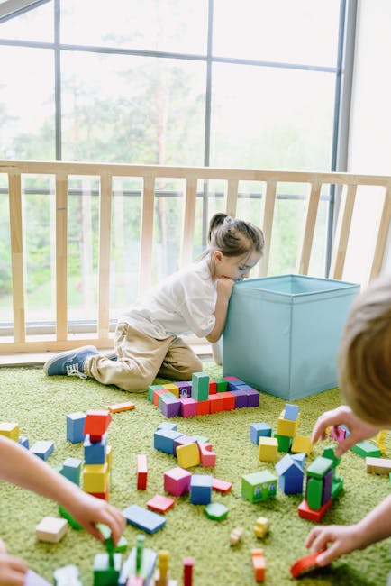 Children playing with vibrant building blocks indoors, enjoying leisure time.